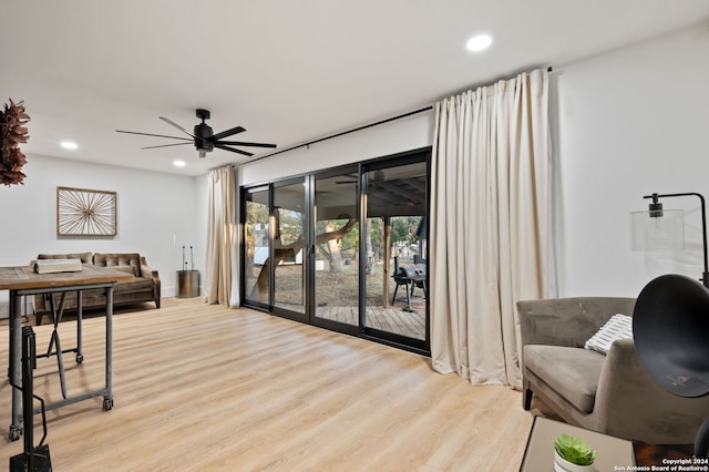 interior space with ceiling fan and light hardwood / wood-style flooring