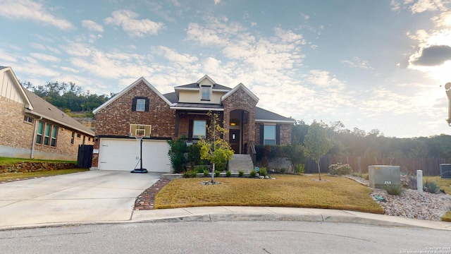 front facade with a front yard and a garage