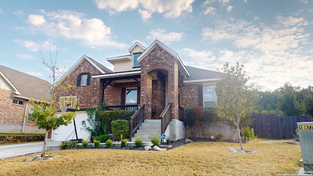 view of front of property featuring a front yard and a garage