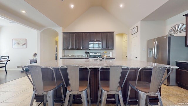 kitchen featuring a spacious island, appliances with stainless steel finishes, and a kitchen breakfast bar