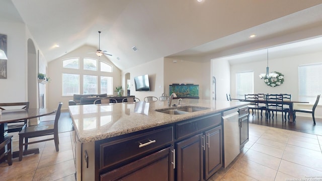 kitchen featuring ceiling fan with notable chandelier, sink, dishwasher, hanging light fixtures, and an island with sink