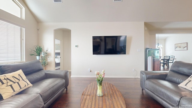 living room featuring lofted ceiling and dark hardwood / wood-style flooring