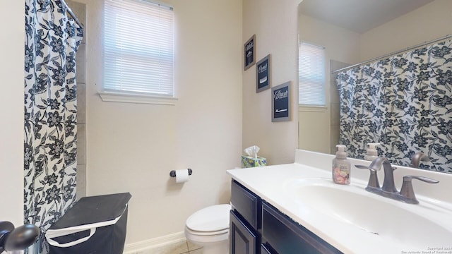 bathroom with vanity, tile patterned flooring, and toilet