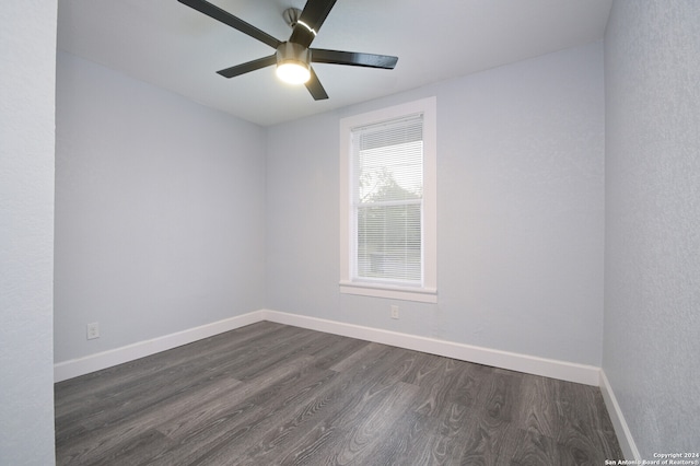 unfurnished room with ceiling fan and dark hardwood / wood-style floors