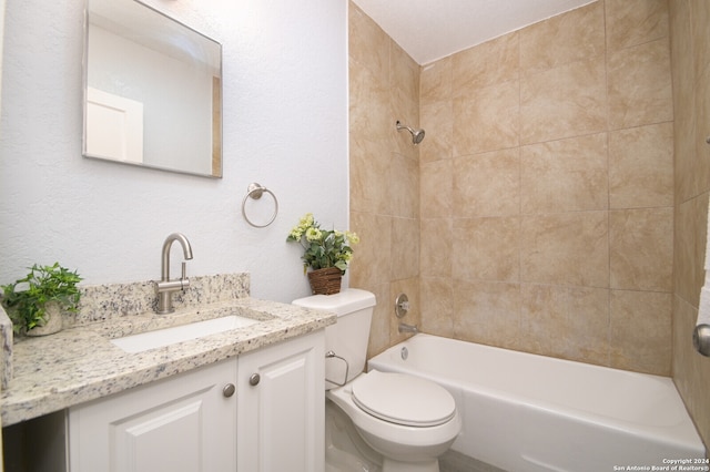 full bathroom with toilet, vanity, and tiled shower / bath