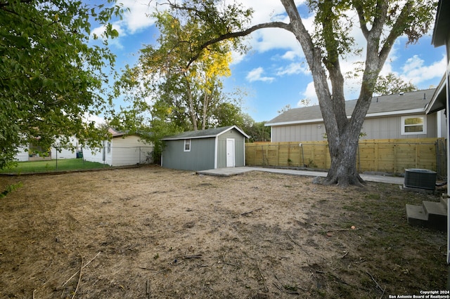 view of yard with a storage unit and central AC