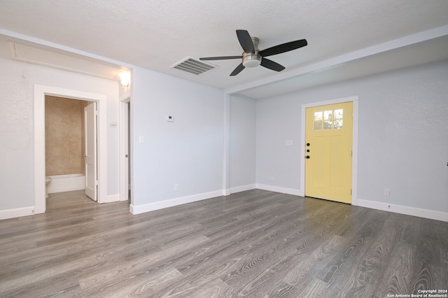 unfurnished room featuring wood-type flooring, a textured ceiling, and ceiling fan