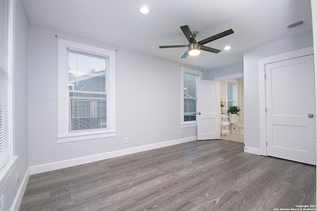 spare room featuring ceiling fan and dark hardwood / wood-style flooring