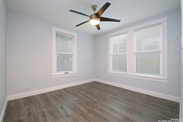 unfurnished room with ceiling fan and dark hardwood / wood-style flooring