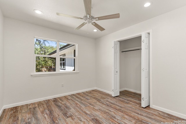 unfurnished bedroom featuring a closet, light wood-type flooring, and ceiling fan