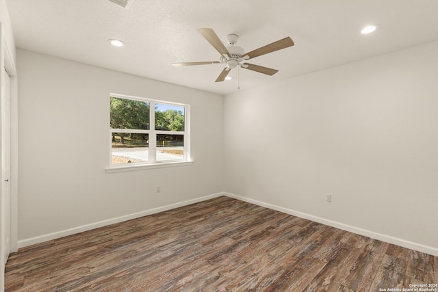 spare room featuring ceiling fan and dark hardwood / wood-style floors