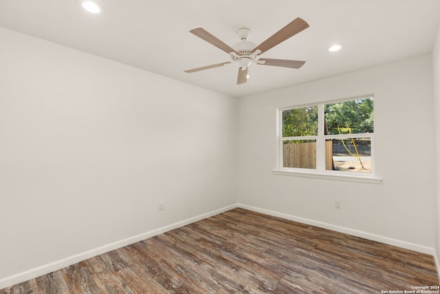 unfurnished room featuring dark hardwood / wood-style floors and ceiling fan