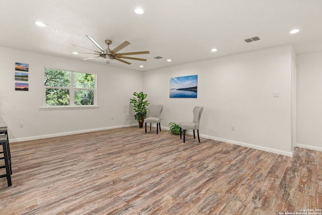 sitting room featuring light wood-type flooring and ceiling fan