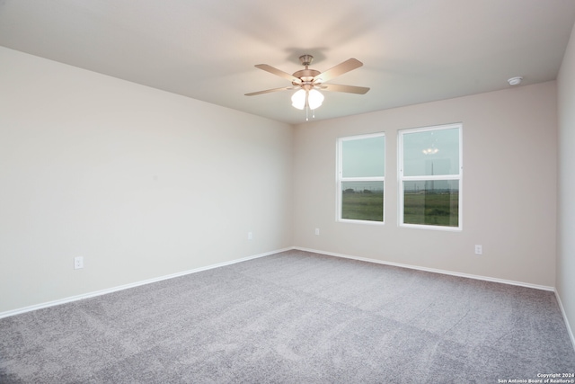 spare room featuring ceiling fan and carpet flooring