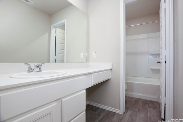 full bathroom featuring bathtub / shower combination, hardwood / wood-style flooring, vanity, and toilet