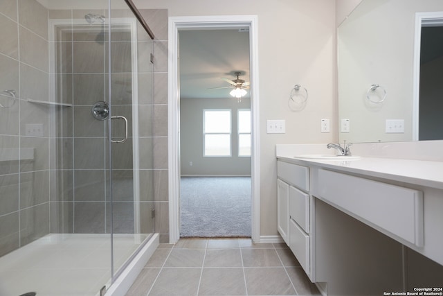 bathroom featuring ceiling fan, vanity, an enclosed shower, and tile patterned floors