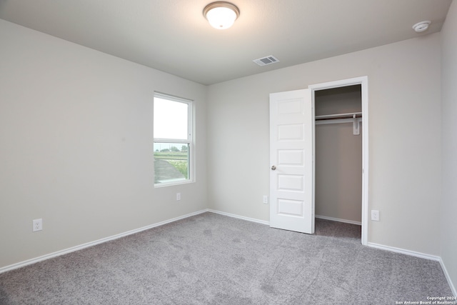 unfurnished bedroom with carpet floors and a closet