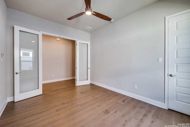 unfurnished bedroom with ceiling fan and light hardwood / wood-style floors