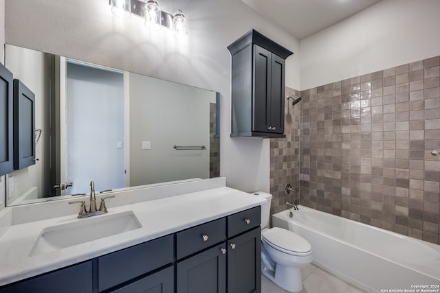 full bathroom with tiled shower / bath combo, vanity, tile patterned floors, and toilet