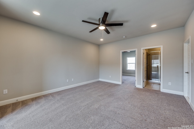 unfurnished bedroom with ensuite bathroom and light carpet