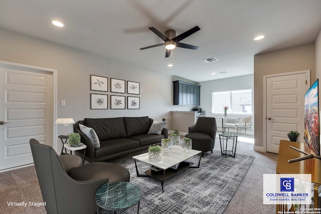 living room featuring carpet floors and ceiling fan