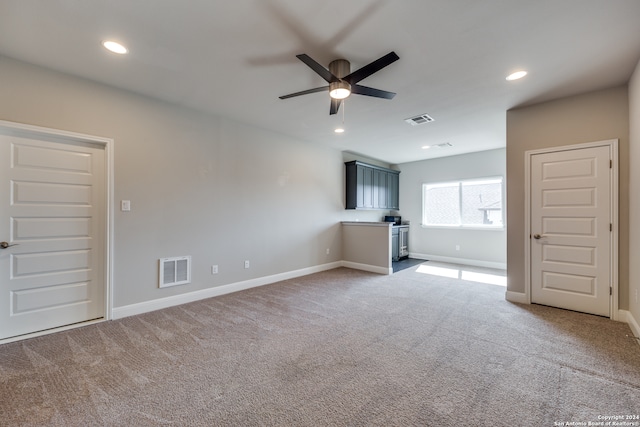 unfurnished living room with ceiling fan and carpet floors