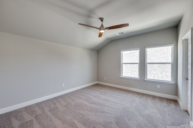 carpeted spare room with lofted ceiling and ceiling fan