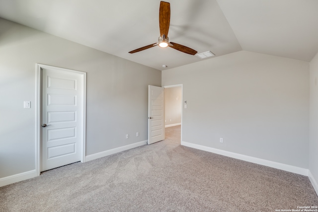 unfurnished bedroom with ceiling fan, light colored carpet, and lofted ceiling