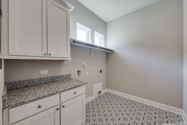 laundry room featuring electric dryer hookup, washer hookup, hookup for a gas dryer, and cabinets