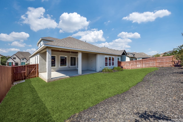 back of property with a patio and a lawn