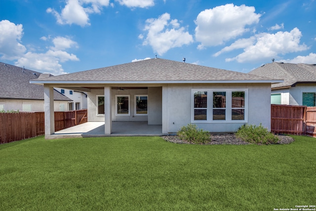 rear view of property featuring a yard and a patio