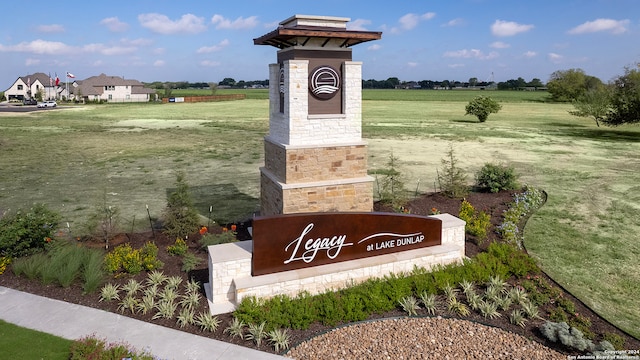 community sign featuring a rural view and a yard