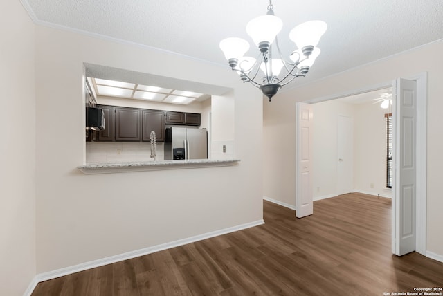 interior space with dark hardwood / wood-style flooring, kitchen peninsula, ornamental molding, dark brown cabinets, and stainless steel refrigerator with ice dispenser