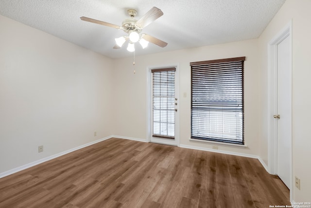 unfurnished room featuring ceiling fan, hardwood / wood-style flooring, and a textured ceiling