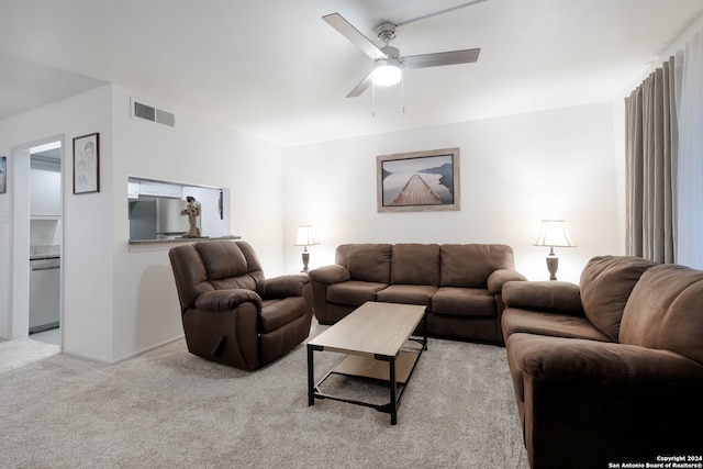 carpeted living room with ceiling fan