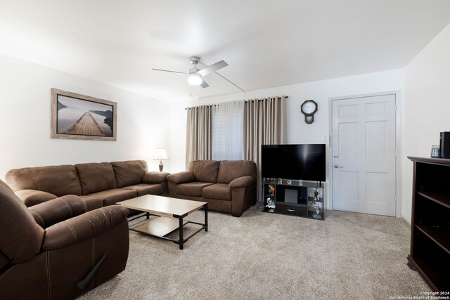 carpeted living room featuring ceiling fan