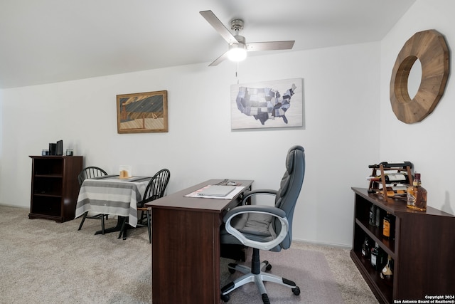 carpeted home office featuring ceiling fan