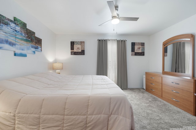 bedroom with ceiling fan and light colored carpet