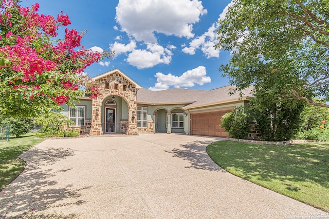 view of front facade with a garage and a front lawn