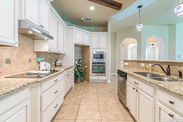 kitchen featuring light stone counters, light tile patterned flooring, sink, white cabinetry, and stainless steel appliances