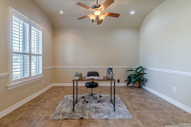 tiled office space with ceiling fan and vaulted ceiling