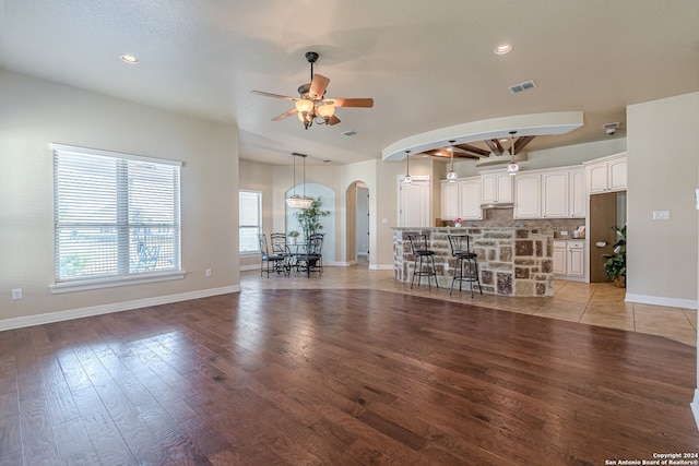 unfurnished living room featuring light hardwood / wood-style flooring and ceiling fan