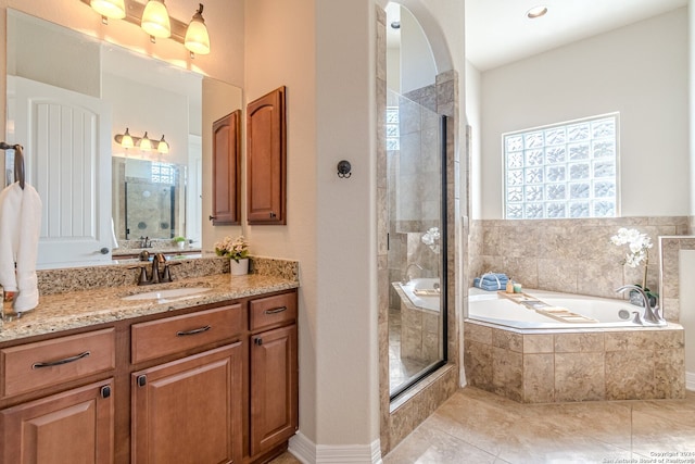 bathroom with tile patterned flooring, vanity, and independent shower and bath