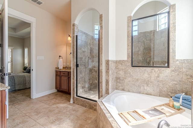 bathroom featuring shower with separate bathtub, tile patterned floors, and vanity