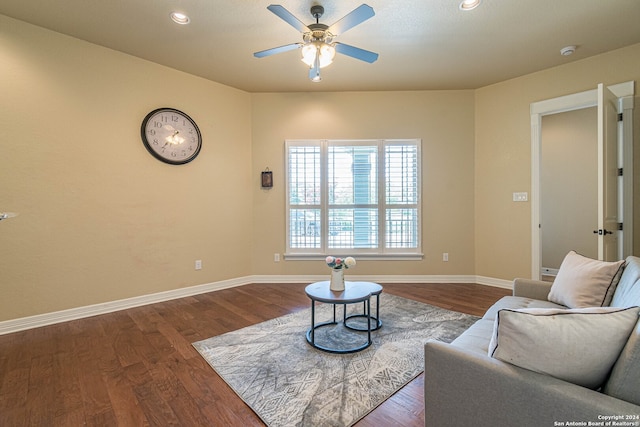 living room with dark hardwood / wood-style floors and ceiling fan