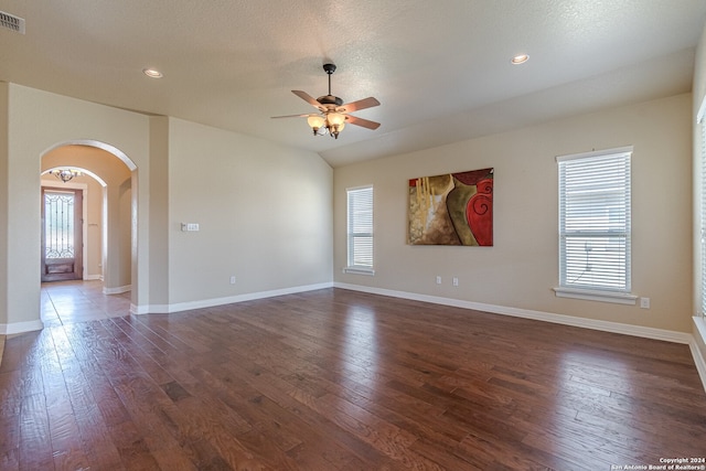 empty room featuring ceiling fan, plenty of natural light, and dark hardwood / wood-style flooring