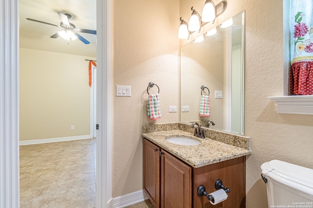 bathroom with ceiling fan, vanity, and toilet