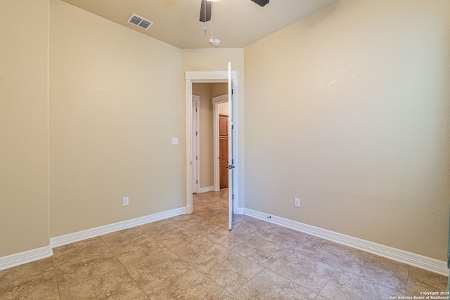 tiled empty room with ceiling fan