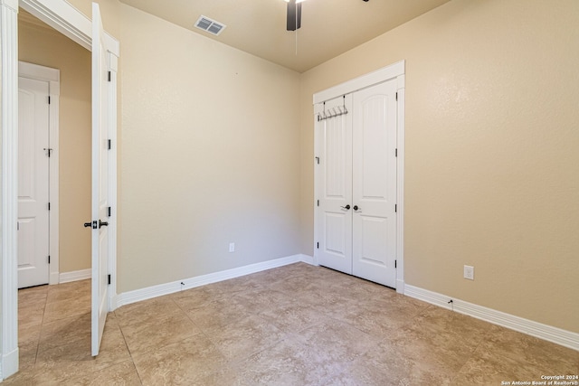 unfurnished bedroom featuring ceiling fan and a closet