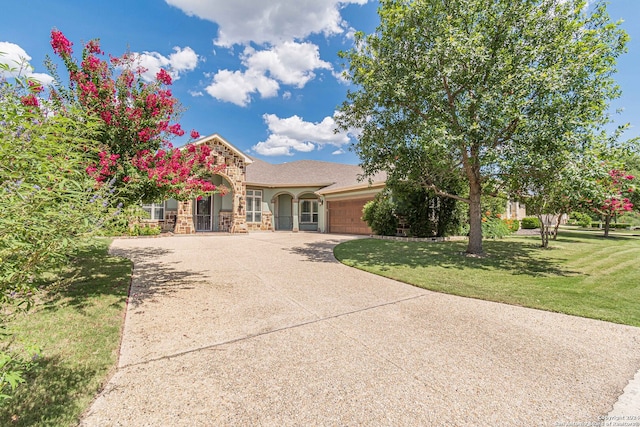 view of front of house with a front yard and a garage